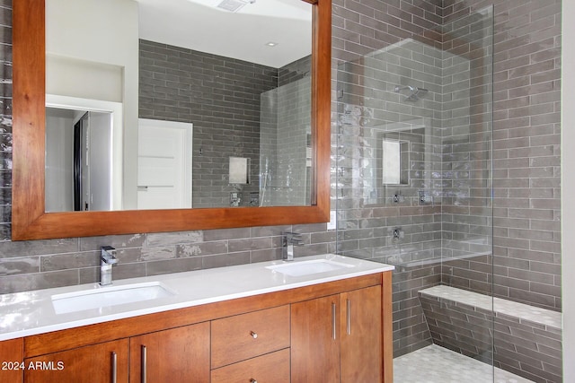 bathroom with tasteful backsplash, vanity, and tiled shower