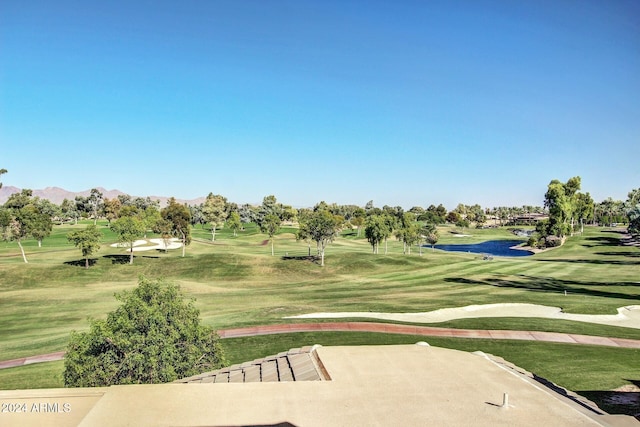 surrounding community featuring a lawn and a mountain view