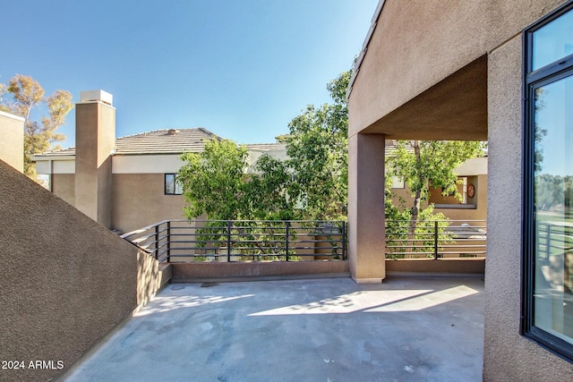 view of patio featuring a balcony