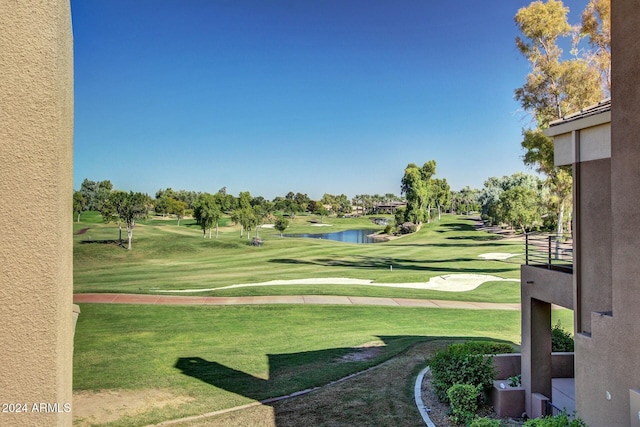 view of community featuring a lawn and a water view