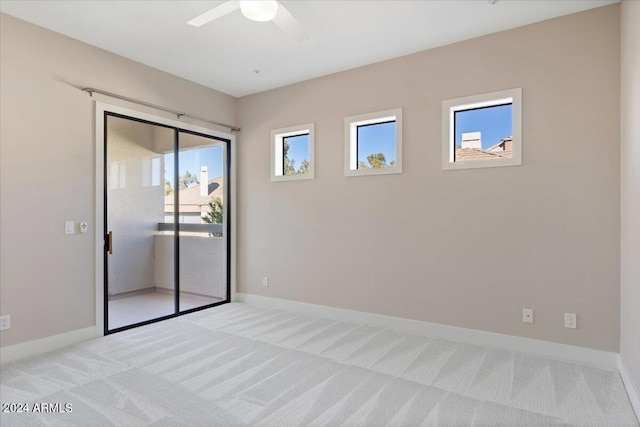 unfurnished room with ceiling fan and light colored carpet