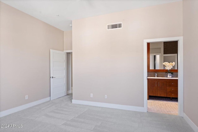 unfurnished room featuring light colored carpet