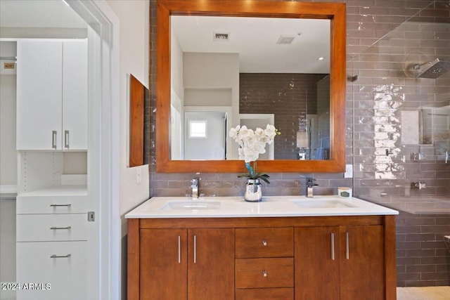 bathroom with vanity and tasteful backsplash