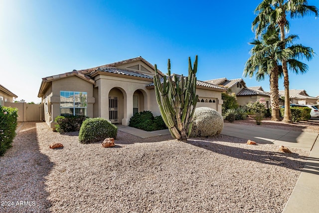 mediterranean / spanish house with a garage