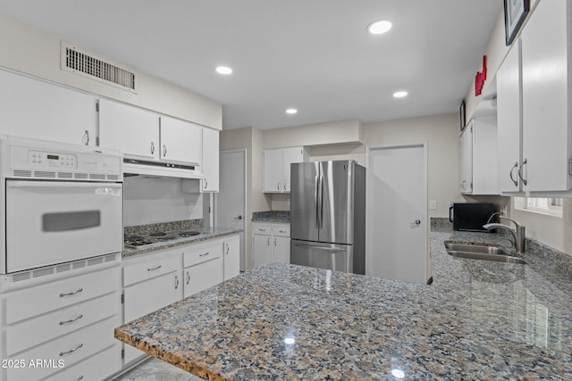 kitchen with stainless steel appliances, sink, and white cabinets