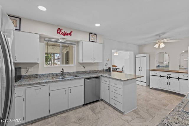 kitchen with white cabinetry, sink, ceiling fan, kitchen peninsula, and stainless steel appliances