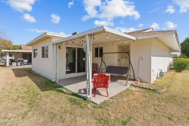 back of property featuring a yard and a patio