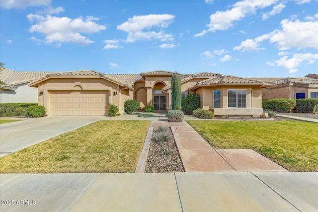 mediterranean / spanish-style house with a garage and a front lawn