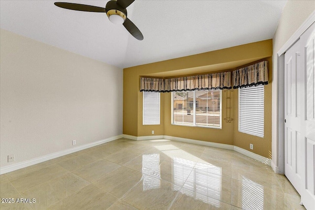 unfurnished room with ceiling fan