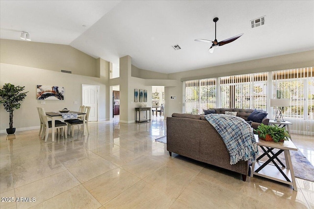 living room with ceiling fan and vaulted ceiling