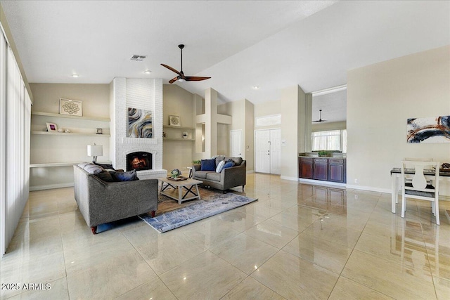 living room featuring a fireplace, ceiling fan, and lofted ceiling