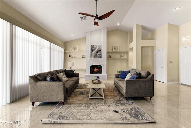 tiled living room featuring ceiling fan, high vaulted ceiling, and a brick fireplace