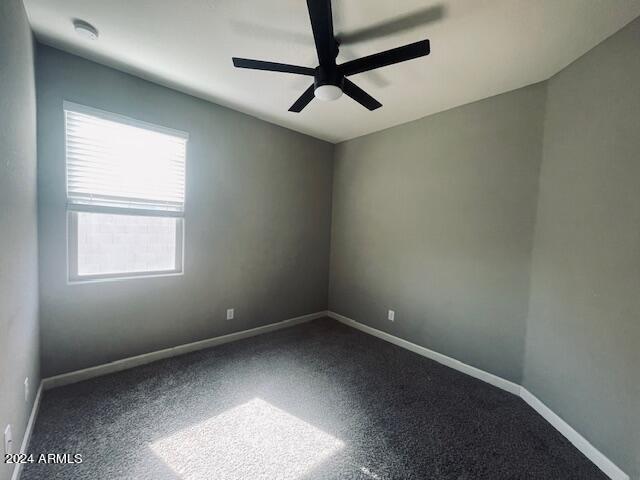 empty room with carpet floors and ceiling fan