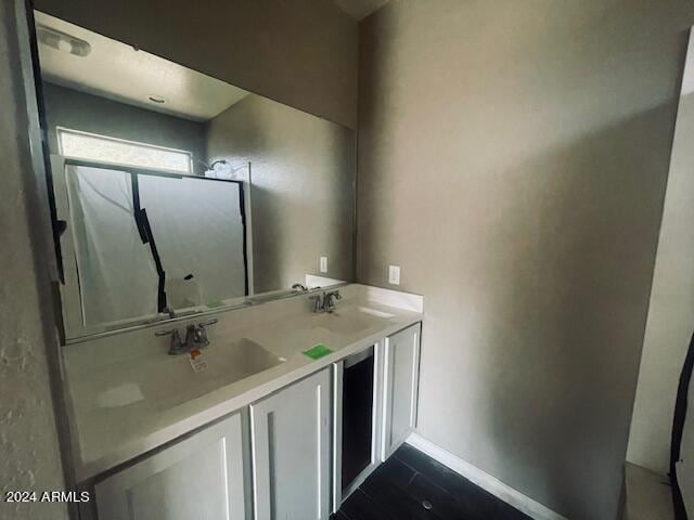 bathroom featuring a shower and vanity