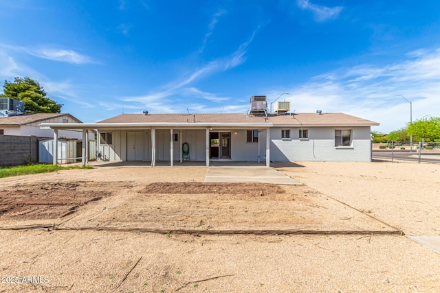 4343 E Union Hills Dr, Phoenix, AZ 85050 - back of property with a patio, board and batten siding, fence, and central AC