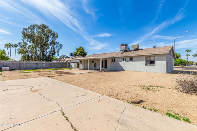 4343 E Union Hills Dr, Phoenix, AZ 85050 - rear view of property featuring a patio, brick siding, a fenced backyard, and central AC