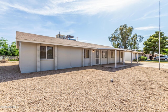 4343 E Union Hills Dr, Phoenix, AZ 85050 - view of front of home with a patio area, concrete block siding, fence, and a shingled roof