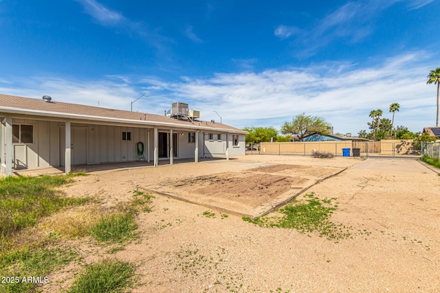 4343 E Union Hills Dr, Phoenix, AZ 85050 - rear view of house featuring board and batten siding, fence, central AC, and a patio