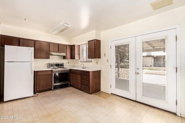 4343 E Union Hills Dr, Phoenix, AZ 85050 - kitchen with freestanding refrigerator, gas range, under cabinet range hood, visible vents, and a sink