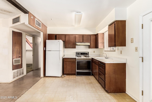 4343 E Union Hills Dr, Phoenix, AZ 85050 - kitchen featuring under cabinet range hood, visible vents, freestanding refrigerator, and gas stove