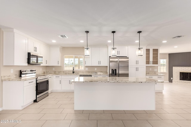 8124 N 45th Ave, Glendale, AZ 85302 - kitchen featuring appliances with stainless steel finishes, plenty of natural light, a center island, recessed lighting, and a sink