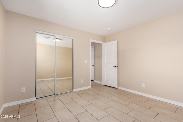 8124 N 45th Ave, Glendale, AZ 85302 - unfurnished bedroom featuring a closet, baseboards, and light tile patterned floors