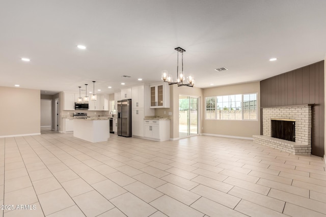 8124 N 45th Ave, Glendale, AZ 85302 - unfurnished living room featuring recessed lighting, a chandelier, a fireplace, and baseboards
