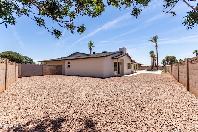 8124 N 45th Ave, Glendale, AZ 85302 - rear view of house featuring a fenced backyard, a patio area, a chimney, and brick siding