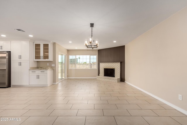 8124 N 45th Ave, Glendale, AZ 85302 - unfurnished living room with recessed lighting, a chandelier, baseboards, and a brick fireplace