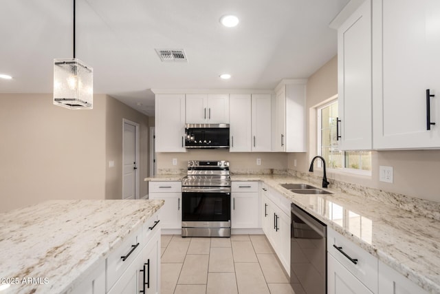 8124 N 45th Ave, Glendale, AZ 85302 - kitchen with appliances with stainless steel finishes, a sink, light tile patterned floors, recessed lighting, and white cabinets