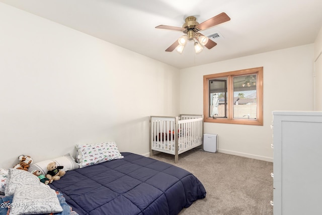 carpeted bedroom featuring visible vents, baseboards, and a ceiling fan