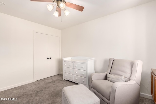 sitting room featuring baseboards, light carpet, and ceiling fan