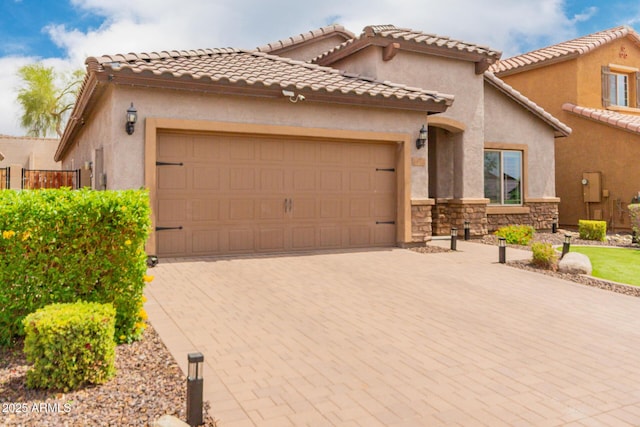 10738 W Rowel Rd, Peoria, AZ 85383 - mediterranean / spanish home with a garage, decorative driveway, stone siding, and stucco siding