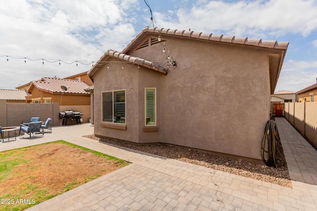 10738 W Rowel Rd, Peoria, AZ 85383 - back of property with a patio, a fenced backyard, a fire pit, and stucco siding