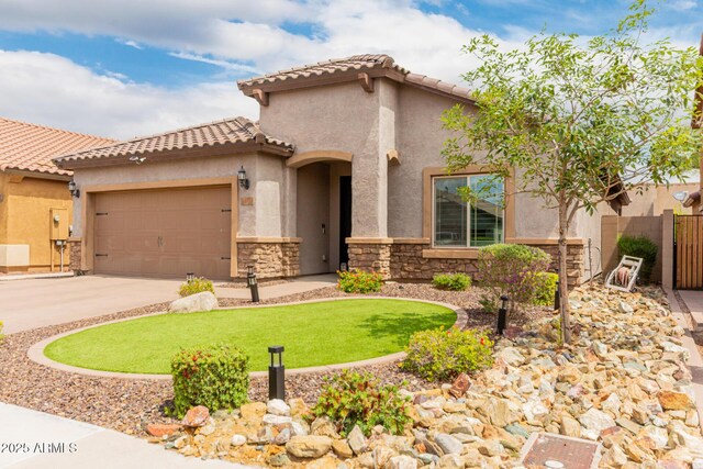 10738 W Rowel Rd, Peoria, AZ 85383 - mediterranean / spanish home with stucco siding, concrete driveway, a garage, stone siding, and a tile roof