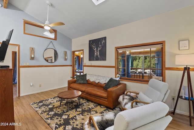 living room with light hardwood / wood-style flooring, ceiling fan, and lofted ceiling