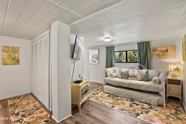 sitting room with wood-type flooring and a textured ceiling