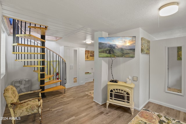 interior space with wood-type flooring and a textured ceiling