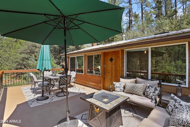 view of patio / terrace featuring an outdoor living space with a fire pit