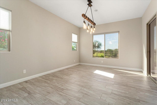 spare room featuring an inviting chandelier