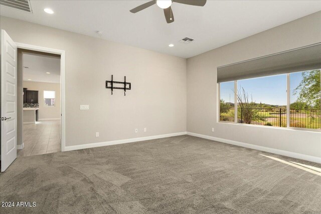 carpeted empty room with ceiling fan