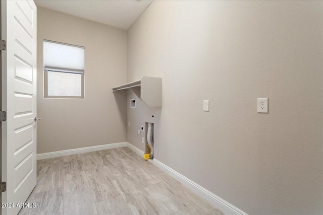 washroom featuring light hardwood / wood-style floors, hookup for a gas dryer, and hookup for a washing machine