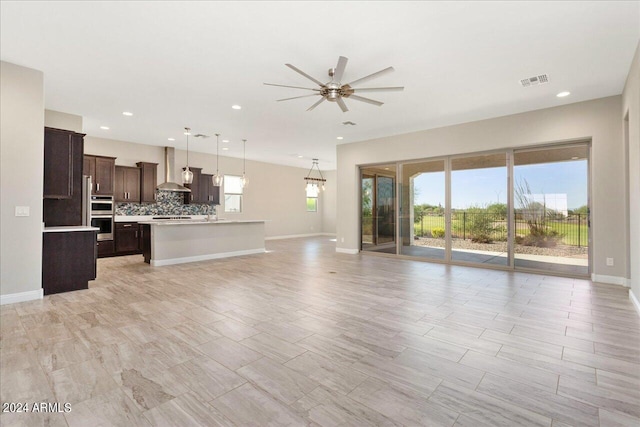 unfurnished living room with light hardwood / wood-style floors and ceiling fan