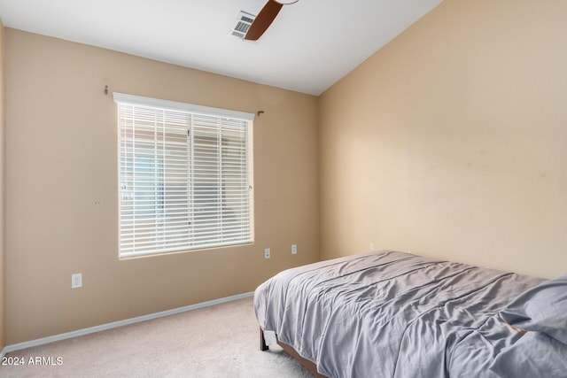 carpeted bedroom featuring lofted ceiling and ceiling fan