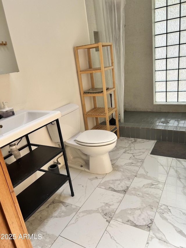 902 S Una Ave, Tempe, AZ 85281 - bathroom featuring toilet, a tile shower, and marble look tile flooring