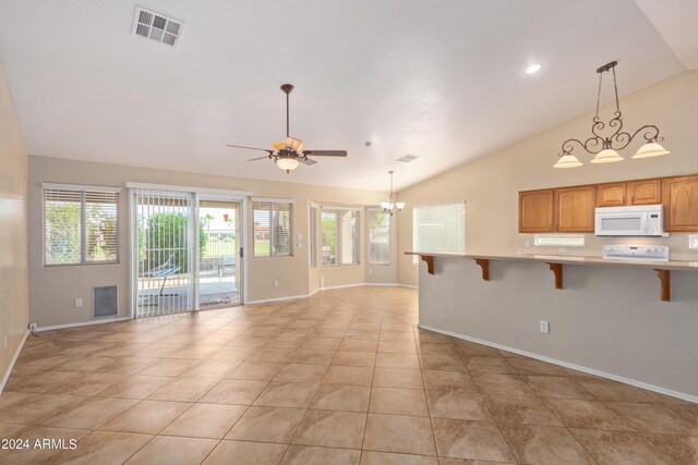 kitchen featuring sink, white appliances, ceiling fan with notable chandelier, light tile patterned floors, and hanging light fixtures