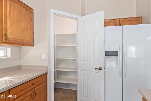 empty room featuring ceiling fan, vaulted ceiling, and light carpet