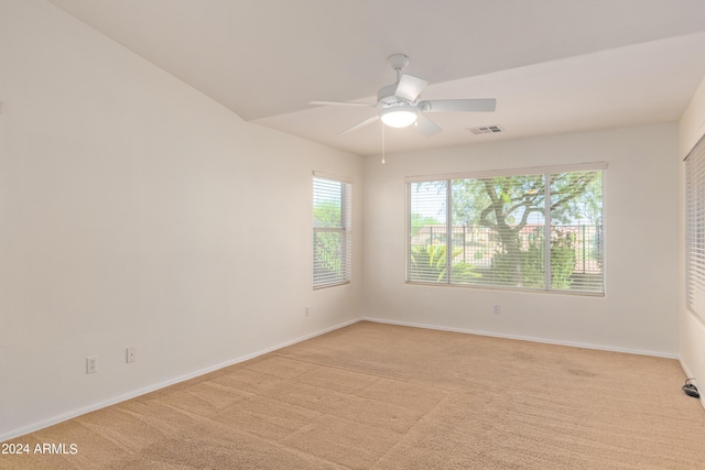 spare room with ceiling fan and light colored carpet