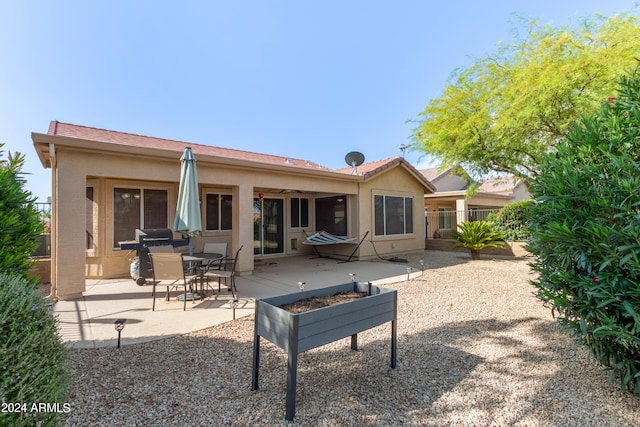 back of property featuring a patio area