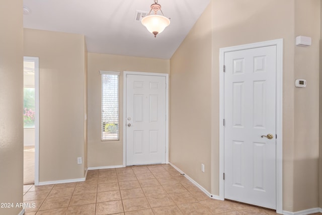 entrance foyer featuring light tile patterned floors and a wealth of natural light